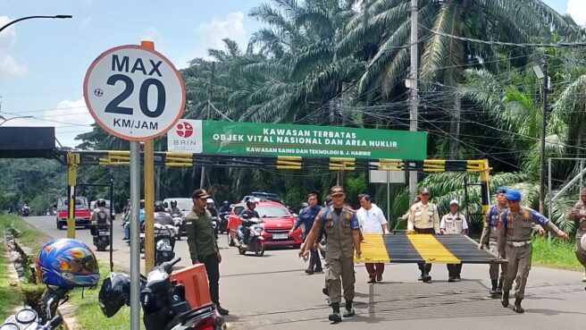 Petugas Satpol PP Tangsel membongkar pagar di akses jalan Muncul-Parung yang hendak ditutup BRIN. Foto: ist